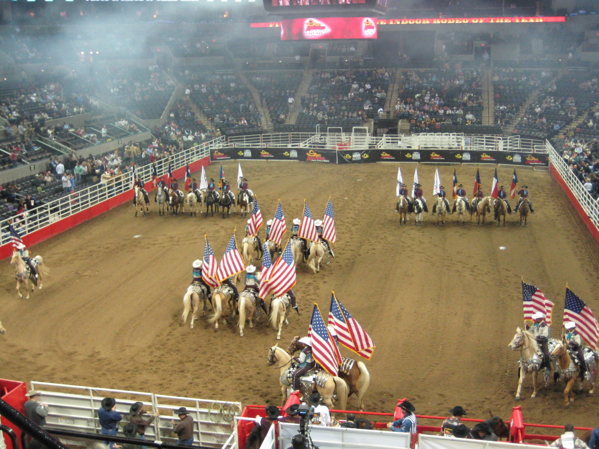 Horses parading in rodeo ring