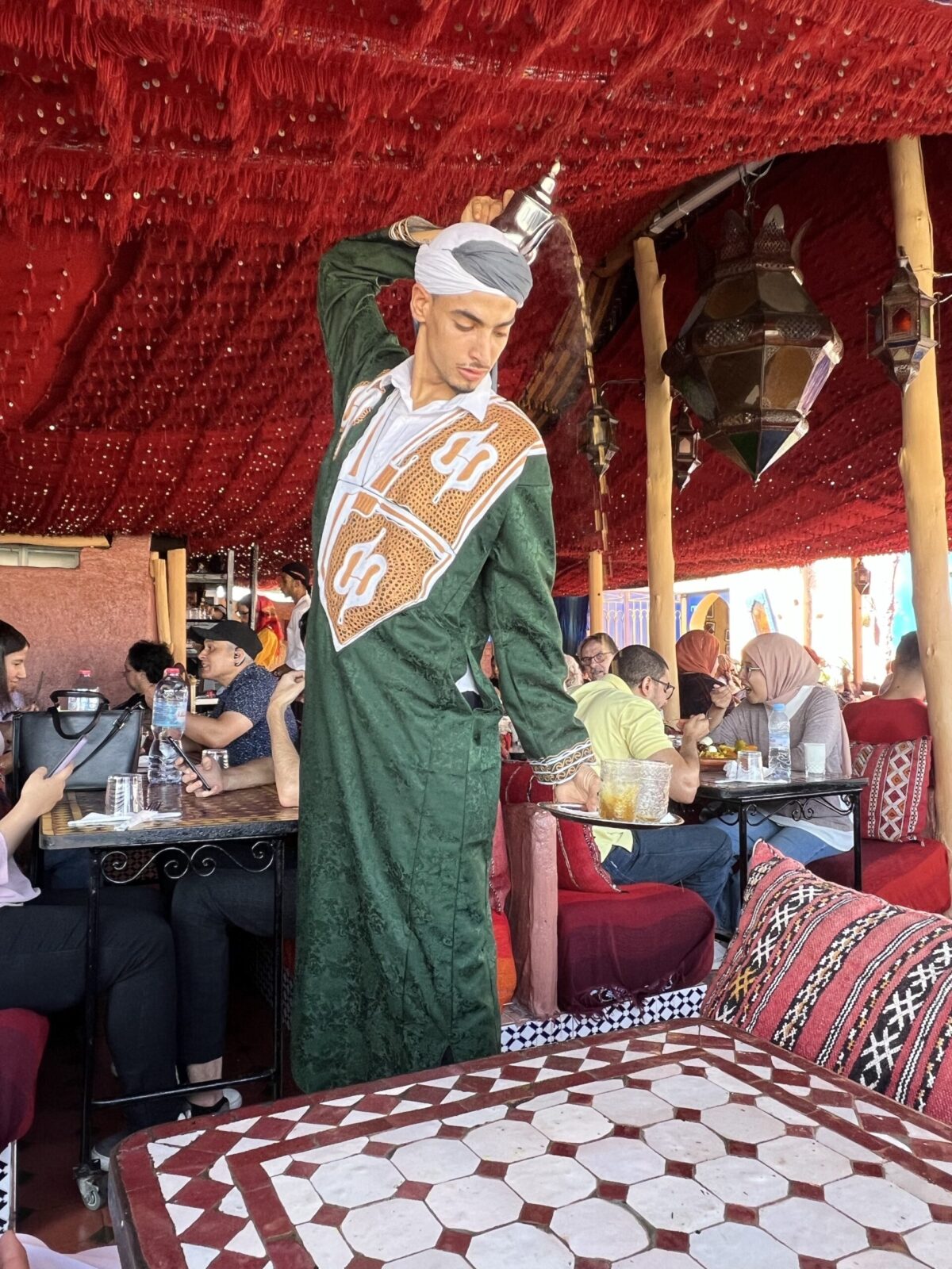 costumed waiter pouring tea in Morocco