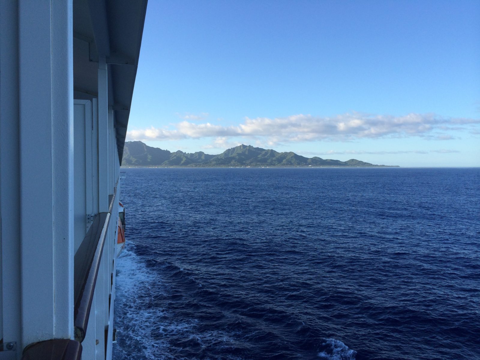 on a ship with islands in the background