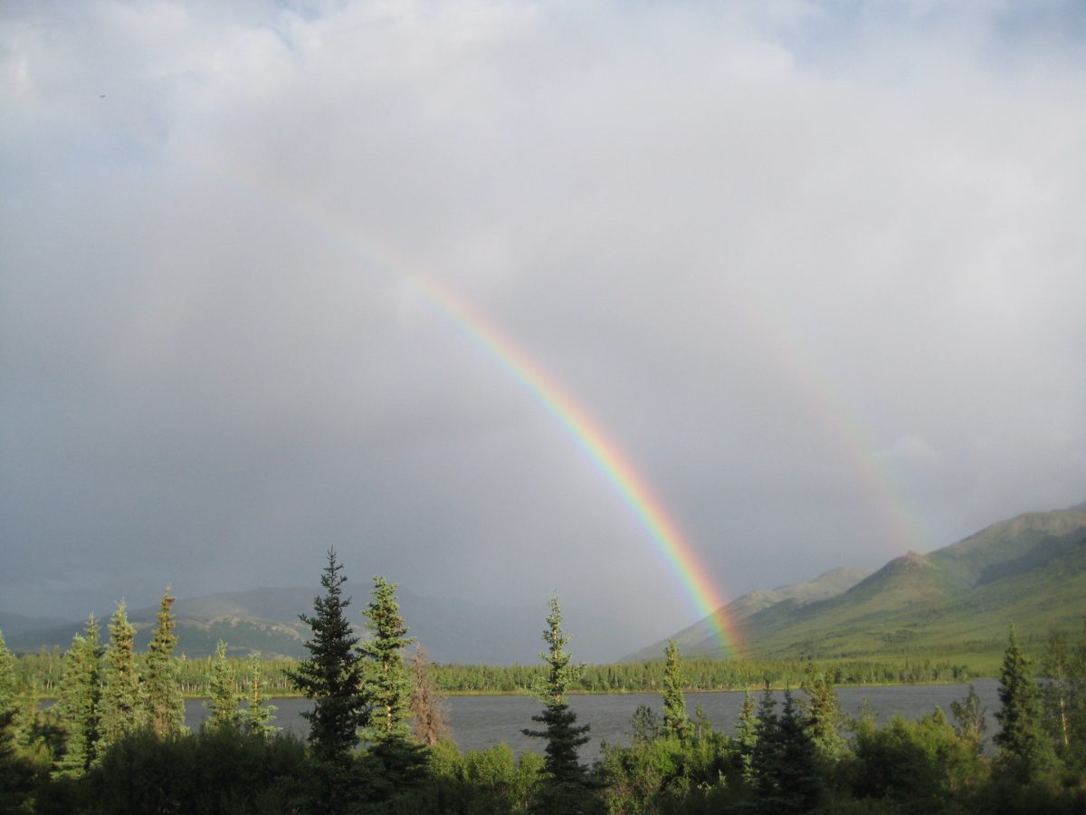two rainbows over lake