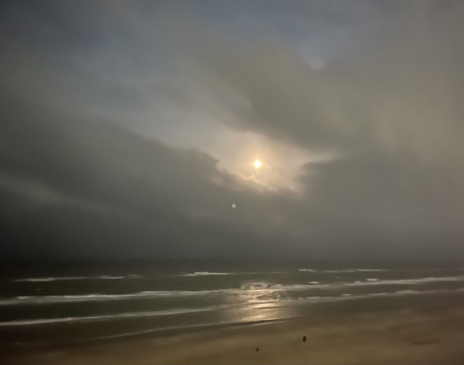 moon rises over the ocean