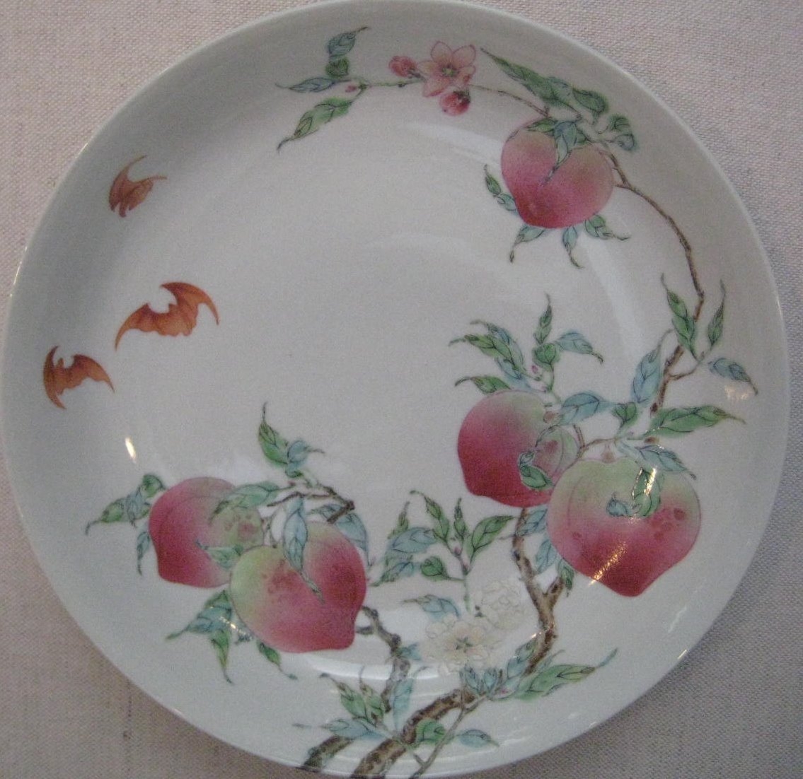 porcelain plate with peaches and bats