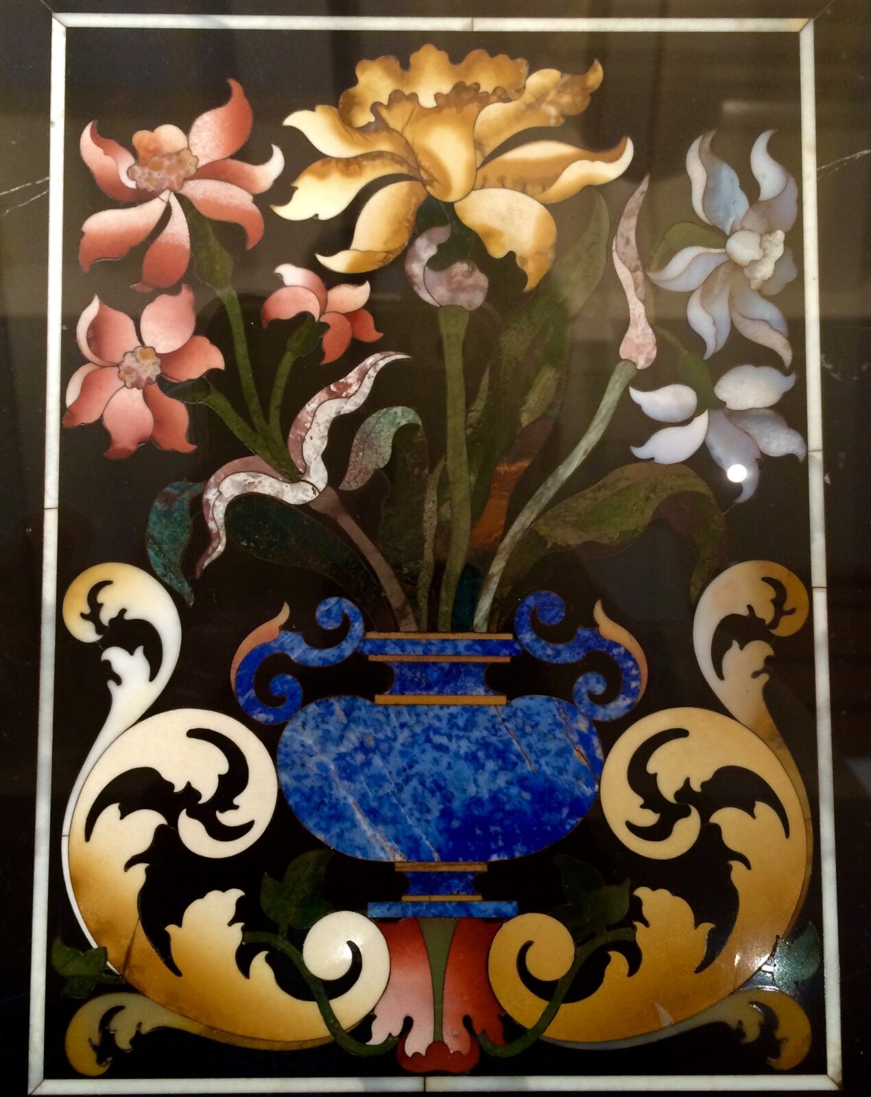 flowers in a vase made with mosaic tiles