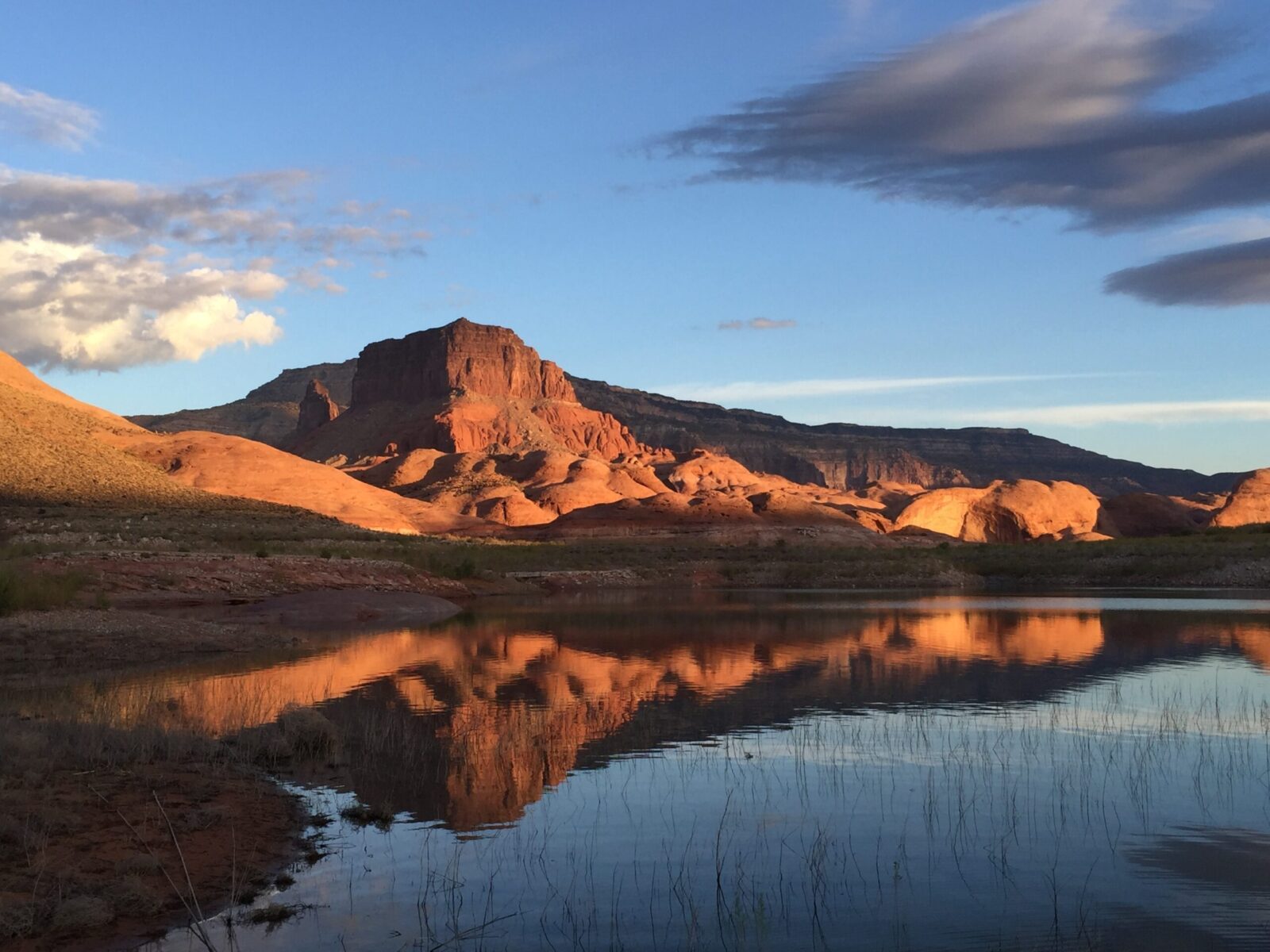 red mountains reflected in blue water